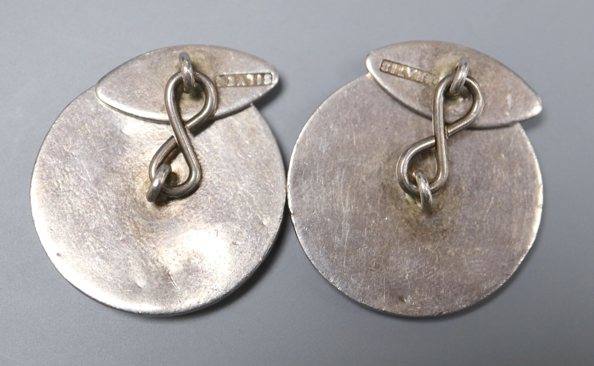 A pair of white metal (stamped silver) and enamel longboat circular cufflinks, 27mm, gross 25.7 grams.